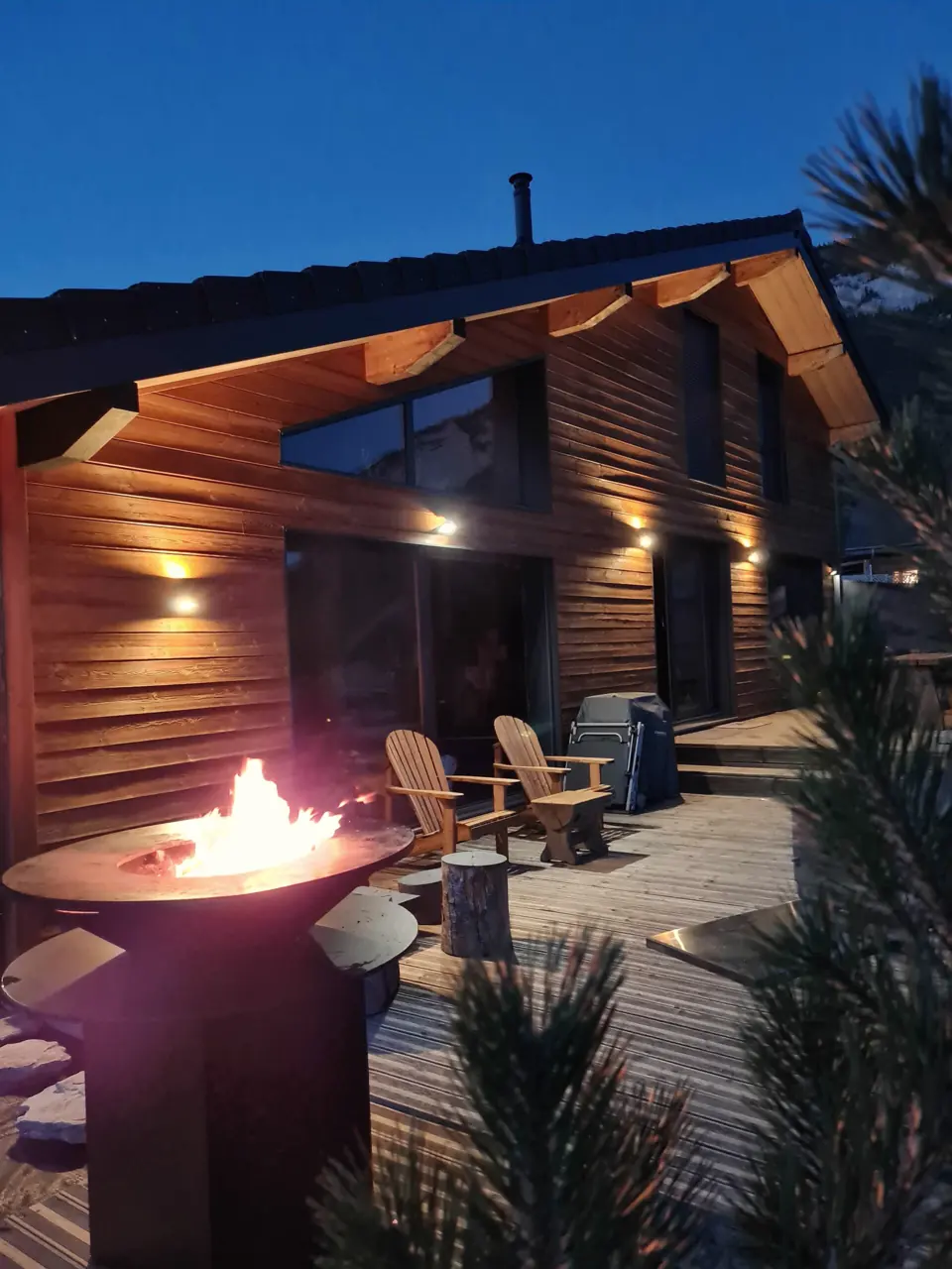The fire pit lit on the terrace as night falls