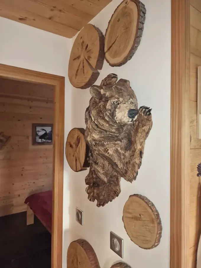 Carved bear and logs on the wall